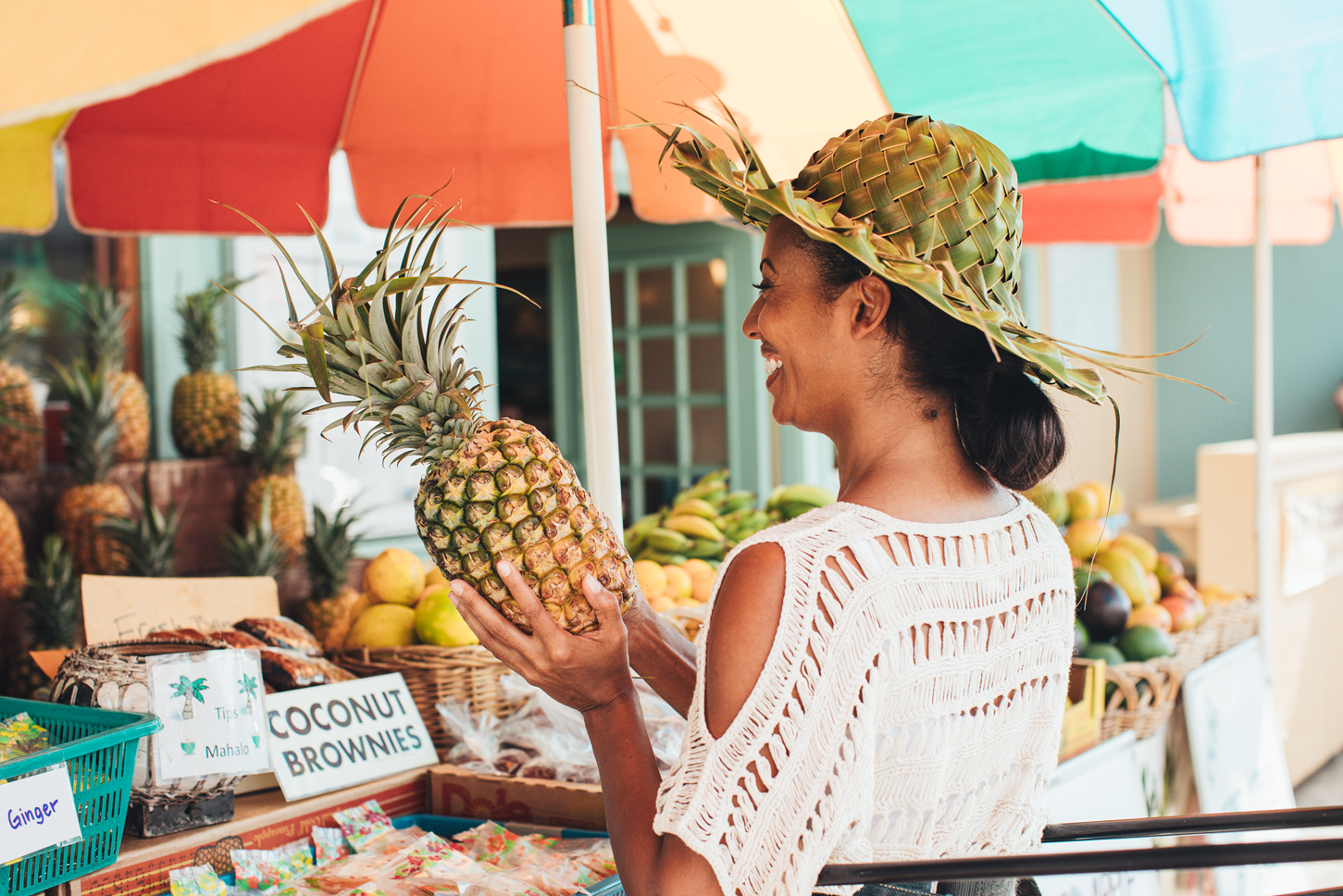 local resident holding a pineapple at a farmer's market