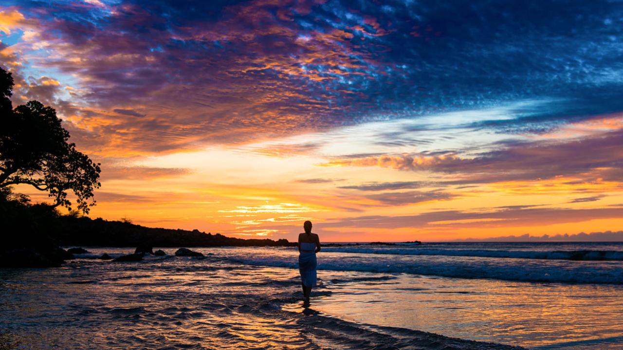 Woman on beach at dusk