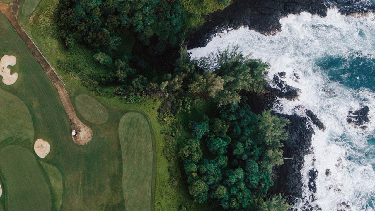 Aerial of golf course and ocean in Kauai