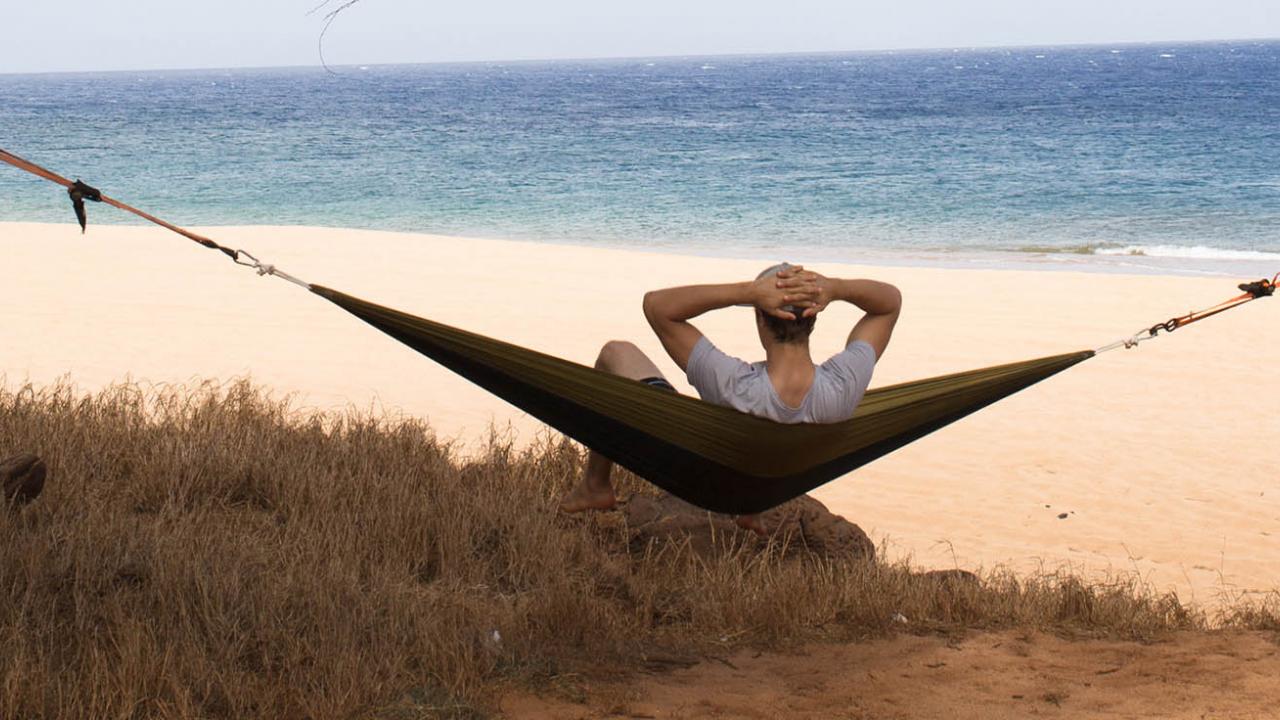 Man on hammock looking out into ocean on Lanai