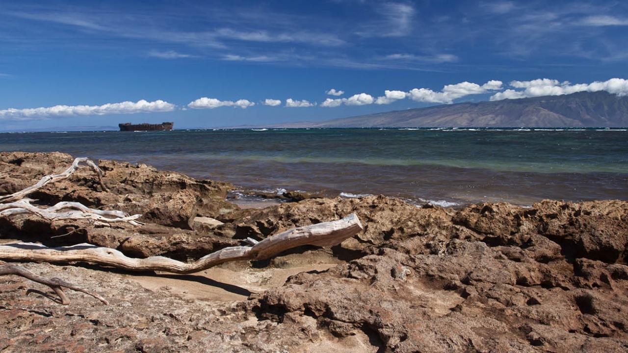 Rocky sand beach with ocean in Lanai