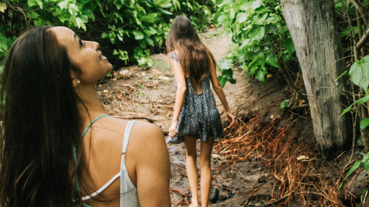Ladies walking through gardens Lanai