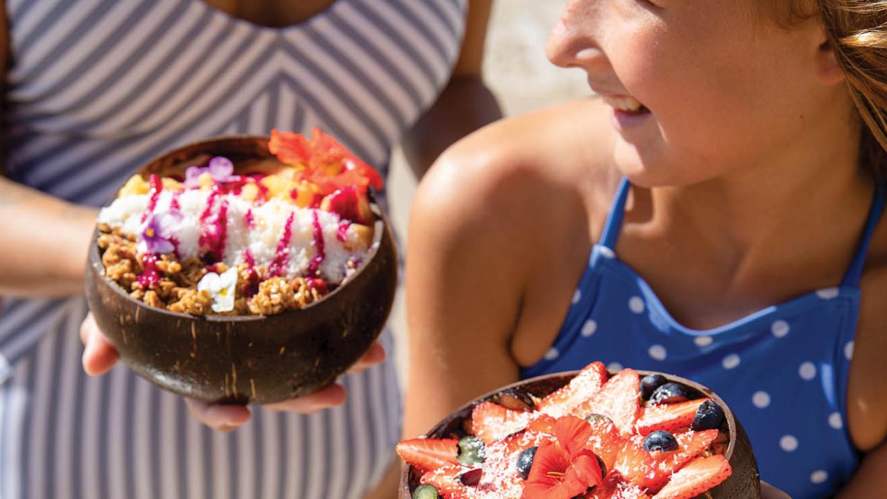 Girl and mom with fruit bowls