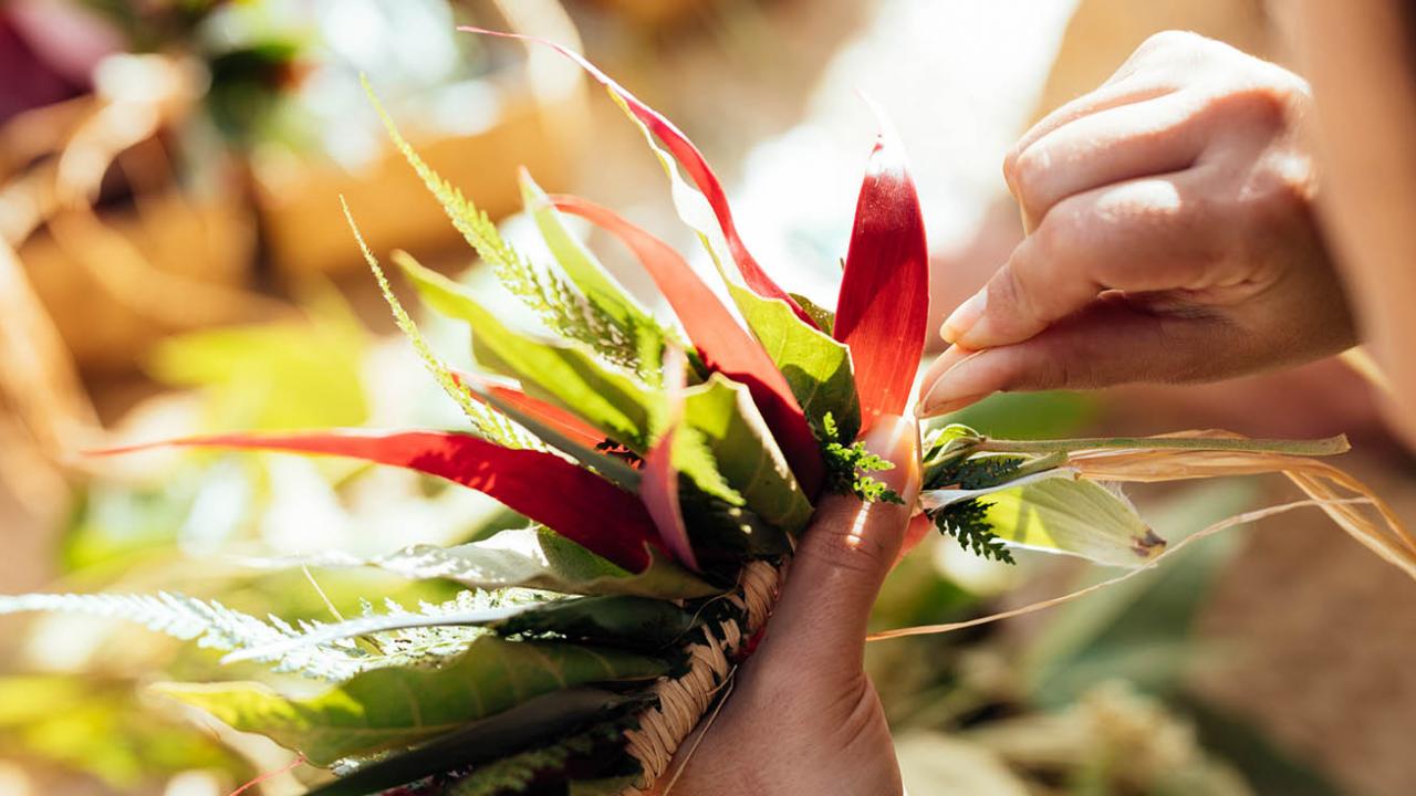 Woman making lei - close up of her hands