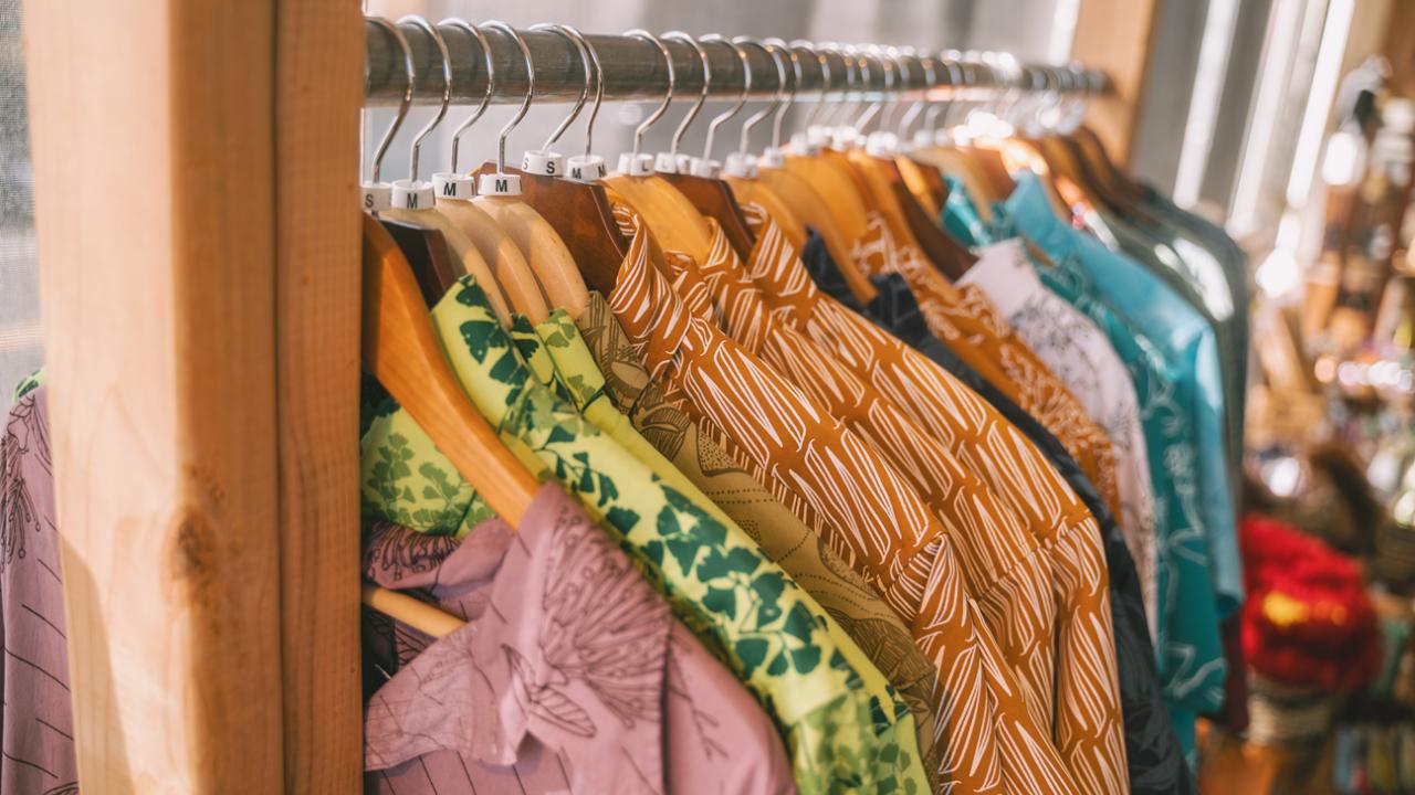 shirts hanging on a rack in a clothing store