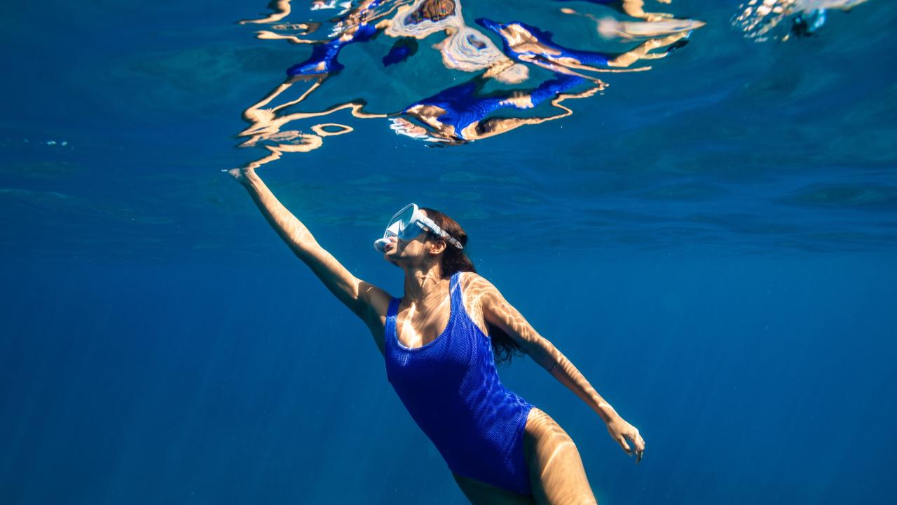woman snorkeling just under the surface of the water