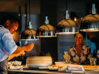 Chef Isaac serving a guest
