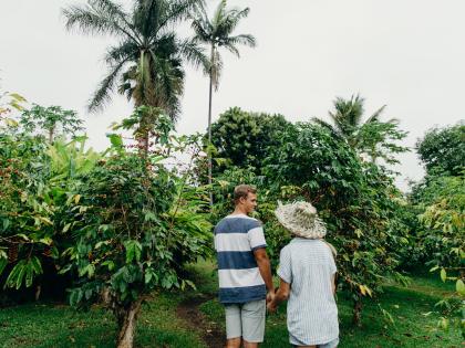 Man and woman in a Kona Coffee field