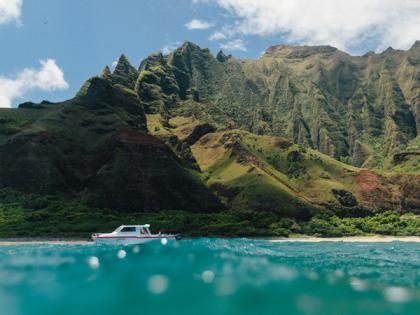 Kauai aqua blue waters with mountain in background