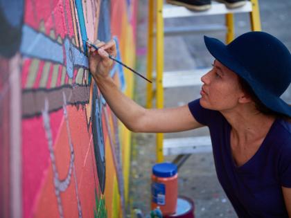 An artist painting a mural