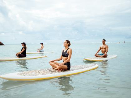 Stand up paddleboard yoga class at Ala Moana Beach