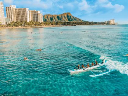 Catching a wave on an outrigger canoe