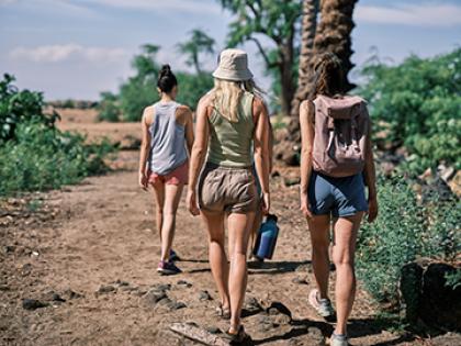 People walk on a trail
