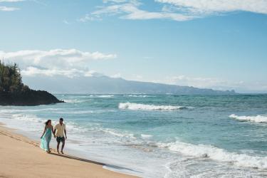 Couple walk along a Maui Beach