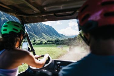 two people in a four wheeler driving